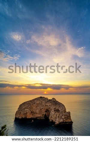 Small island on the coast of Sardinia in the light of the sunset