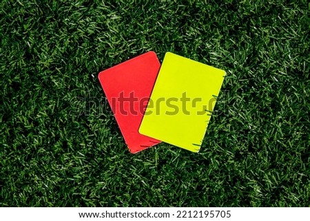 Referee soccer, football game, red and yellow cards on green grass. Two penalty cards for the referee Royalty-Free Stock Photo #2212195705