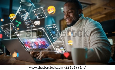 African American Project Manager Working on Computer in Office. Augmented Reality Social Media Icons Appear From Worker's Laptop. Internet of Things, Internet Connectivity and Online Concept. Royalty-Free Stock Photo #2212199147