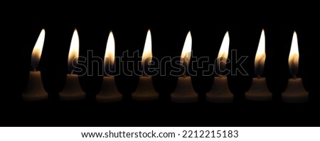 The candle flame glows in the dark dark night as a background decoration in religious ceremonies and birthday celebrations. Many people have a happybrightromantic holiday.