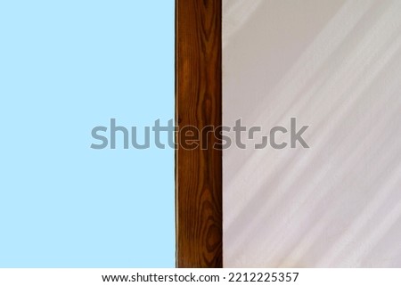 The photo shows a part of the window with a wooden slat                               