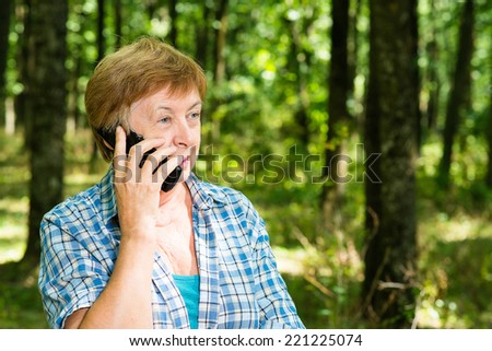 an elderly woman with a phone