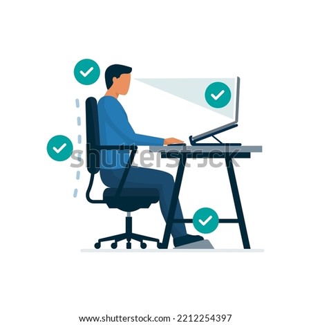 Ergonomic workspace and proper sitting posture at desk, man sitting properly at desk and working with a laptop Royalty-Free Stock Photo #2212254397