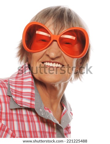  Senior woman wearing big sunglasses doing funky action isolated on white background 