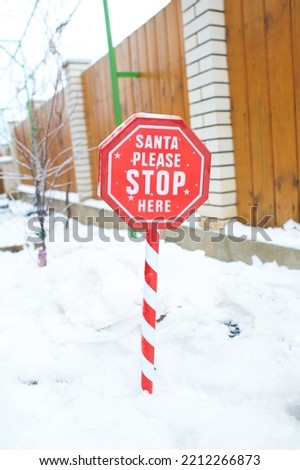 Sign to invite Santa to stay for a while. Funny sign for the Christmas weekend.
