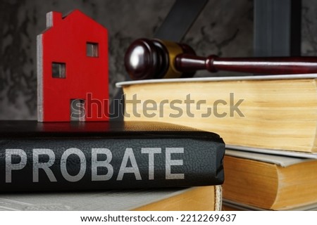 Probate law book and model of house on it. Royalty-Free Stock Photo #2212269637