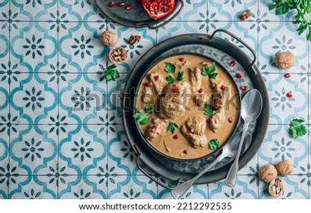 Satsivi is a cold Georgian dish made from boiled chicken pieces and walnut sauce. Royalty-Free Stock Photo #2212292535