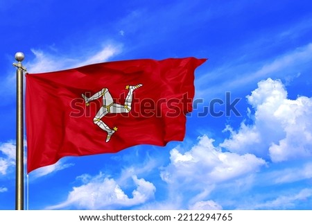 Isle Of Man Flag Waving In The Wind On A Beautiful Summer Blue Sky Royalty-Free Stock Photo #2212294765