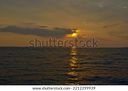 This is a landscape picture of a sunset over the ocean.