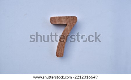 wooden number seven , selective focus number white background . Top view isolated photo. 