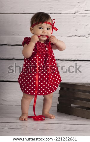 Smiling Baby Girl in red dress 
