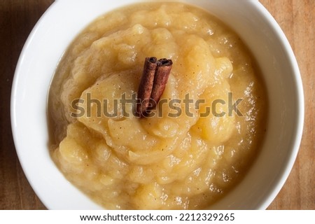 An overhead view of a Healthy Organic Applesauce with Cinnamon on a wooden table. Apple compote. Healthy desserts.. Royalty-Free Stock Photo #2212329265