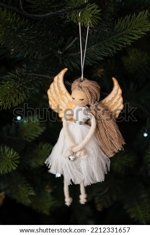 Christmas tree decoration, white angel with bokeh on green tree