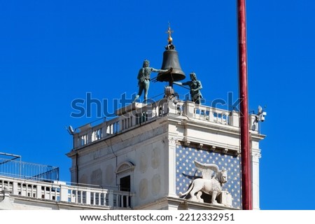 Clock tower with a winged lion and two marshes striking a bell - an early Renaissance building (1497) in Venice on the north side of Piazza San Marco. Zodiac clocks of the early Italian Renaissance.