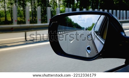 look in the rear view mirror of a car Royalty-Free Stock Photo #2212336179