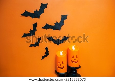 A collage layout for the Halloween holiday. Applications, figures in the shape of black bats and candles. View from above. High-quality horizontal photography background