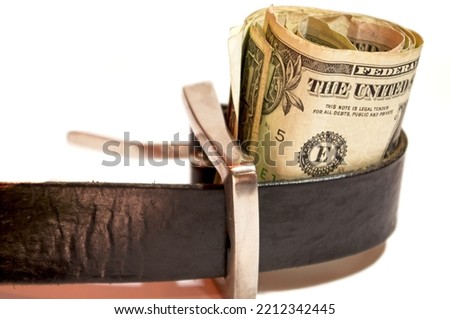Concept - belt around roll of money Royalty-Free Stock Photo #2212342445