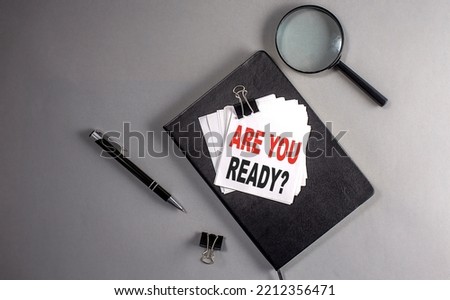 ARE YOU READY Text on sticky on black notebook , business concept