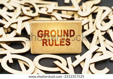 Education concept. Among the wooden letters is a sign with the inscription - GROUND RULES