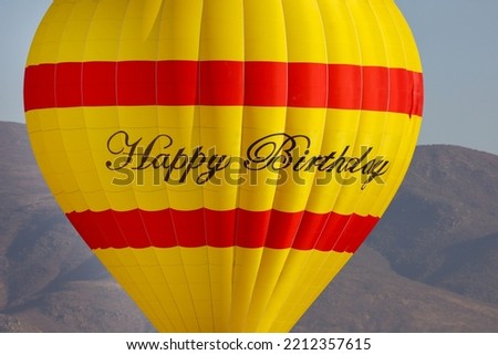 A bright colorful hot air balloon with Happy Birthday on it.