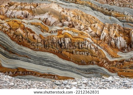 Natural rock texture of a colorful rock formations in silence beach (playa del Silencio) in Asturias, north of Spain. Royalty-Free Stock Photo #2212362831