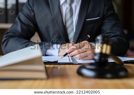 Attorney reading law code, studying constitution to protect human rights closeup, Male lawyer or judge working with Law books, gavel	


