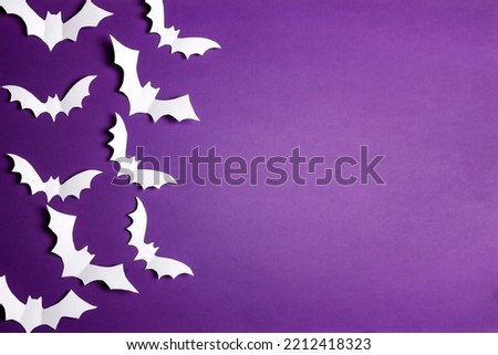 Halloween paper decorations bats on purple background. Flat lay, top view, copy space. Happy halloween banner mockup.