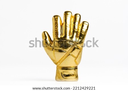 A picture of miniature golden gloves on white background. Award for Best Goalkeeper. Royalty-Free Stock Photo #2212429221
