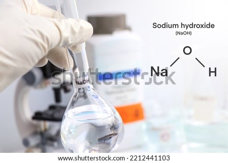 sodium hydroxide in glass, chemical in the laboratory and industry, corrosive chemical Royalty-Free Stock Photo #2212441103