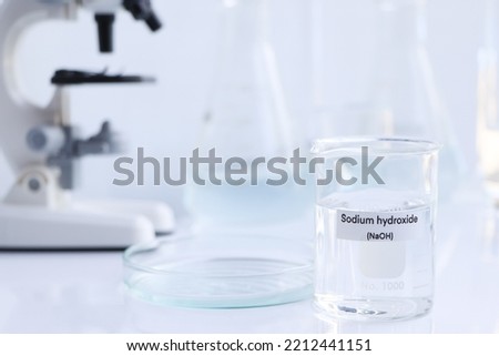 sodium hydroxide in glass, chemical in the laboratory and industry, corrosive chemical Royalty-Free Stock Photo #2212441151