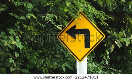 yellow traffic sign with natural background.