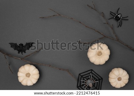 Halloween black background with bats, spiders, pumpkins and twigs. Modern Holiday design. Halloween party border on Dark Gray colour. Flat lay, top view, copy space. Thanksgiving fall decoration. 2022