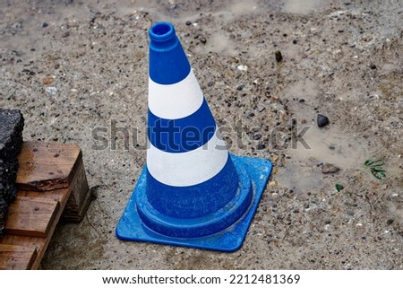 Aerial view of blue and white striped pattern of traffic cone at highway enclosure construction site at City of Zürich on a rainy autumn day. Photo taken October 1st, 2022, Zurich, Switzerland.