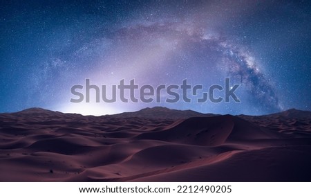 Amazing milky way over the sand dunes of Sahara Desert at sunset - Sahara, Morocco