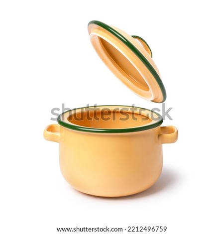 Yellow ceramic cooking pot or saucepan and lid isolated on white background Royalty-Free Stock Photo #2212496759