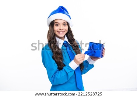 Santa child girl. Teenager child girl holding present box isolated over white studio background. Present, greeting and gifting concept. New Year or Christmas holiday concept.