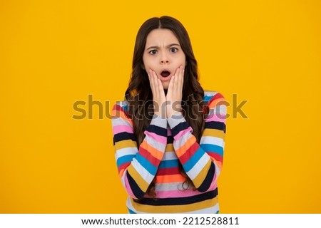 Shocked amazed face, surprised emotions of young teenager girl. Cute preteen girl head shot. Child portrait on isolated background. Beautiful teenager face.