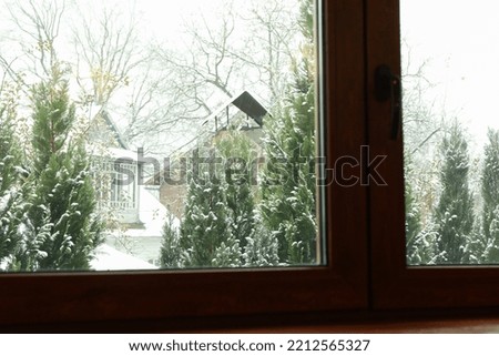 Window of house with view on snowy day