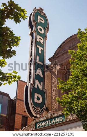 Portland sign between green tree branches with leaves Royalty-Free Stock Photo #221257195
