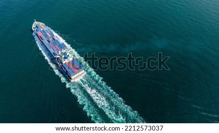 Stern of large cargo ship import export container box on the ocean sea on blue sky back ground concept transportation logistic and service to customer and supply change
