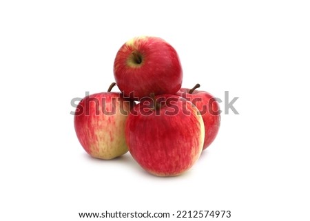 A bunch of red apples lie on a white background.