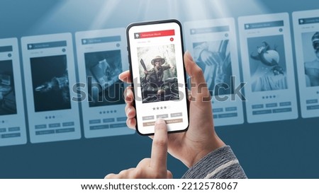 User buying a movie ticket online on smartphone app Royalty-Free Stock Photo #2212578067