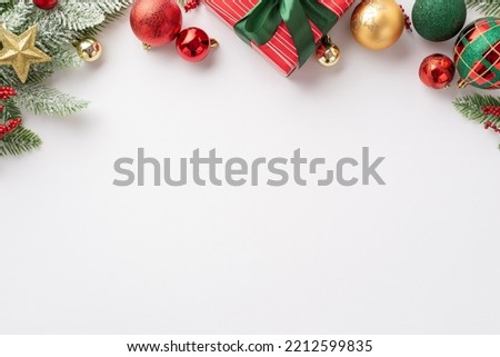 Christmas concept. Top view photo of red green and gold baubles star ornament giftbox with ribbon bow mistletoe berries and pine branch in snow on isolated white background with empty space