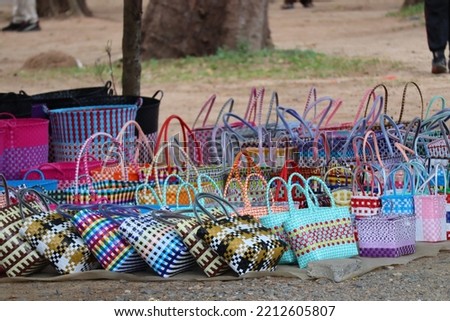 Bags and crafts woven from the fibers of the Palm of petate or Key thatch palm and plastic for sale on the street. Royalty-Free Stock Photo #2212605807
