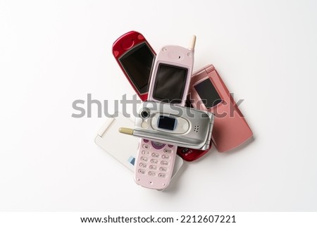Old used cell phone on white background Royalty-Free Stock Photo #2212607221