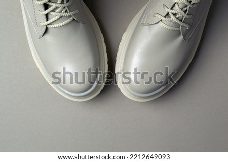 beige women's shoes on a gray background. Autumn shoes. Horizontal image