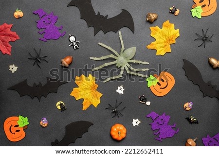 Bright Halloween pattern with decorative pumpkins, bats, spiders and autumn leaves on black background.