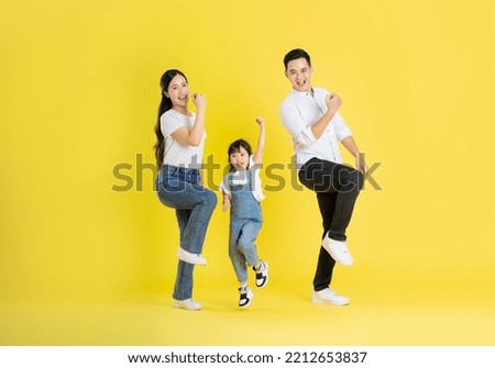 happy asian family image, isolated on yellow background Royalty-Free Stock Photo #2212653837