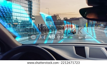 Futuristic Autonomous Self-Driving Concept Car Moving Through City, Head-up Display HUD Showing Infographics: Speed, Distance, Navigation, Fuel. AI Road Scanning. Driver Seat Point of View POV, FPV.