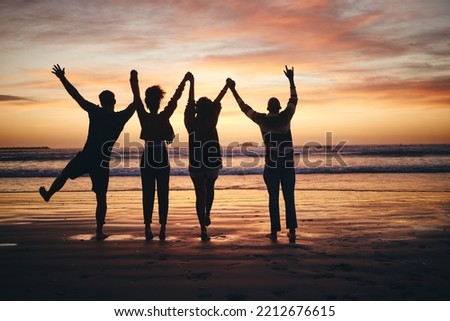 Silhouette, sunset and friends holding hands at the beach on holiday in Miami during summer. Group of people with support, community and calm on a vacation by the water and sea for peace in nature